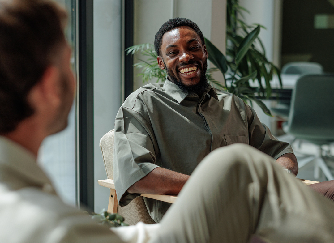 Man smiling during a meeting