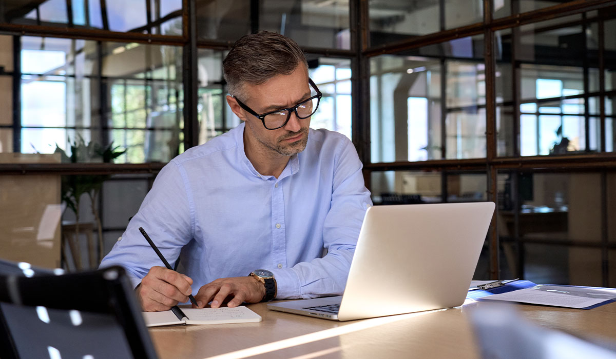 man working at laptop device