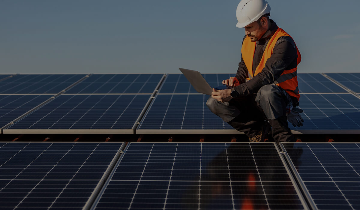 man working on the setup of solar panels