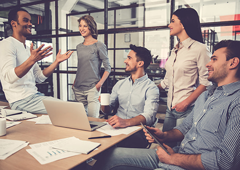 Group of colleagues smiling during a meeting