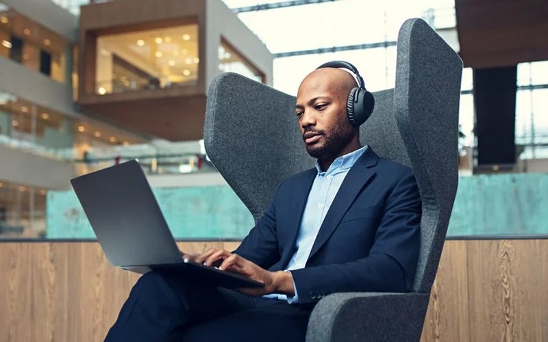Man working in an open space with a headset on