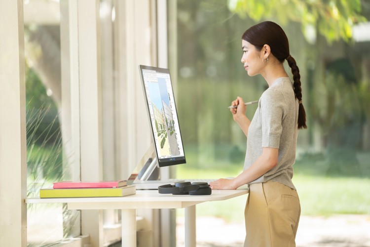 Woman working on Surface Studio 2+