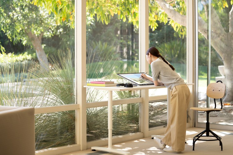 Woman working on Surface Studio 2+